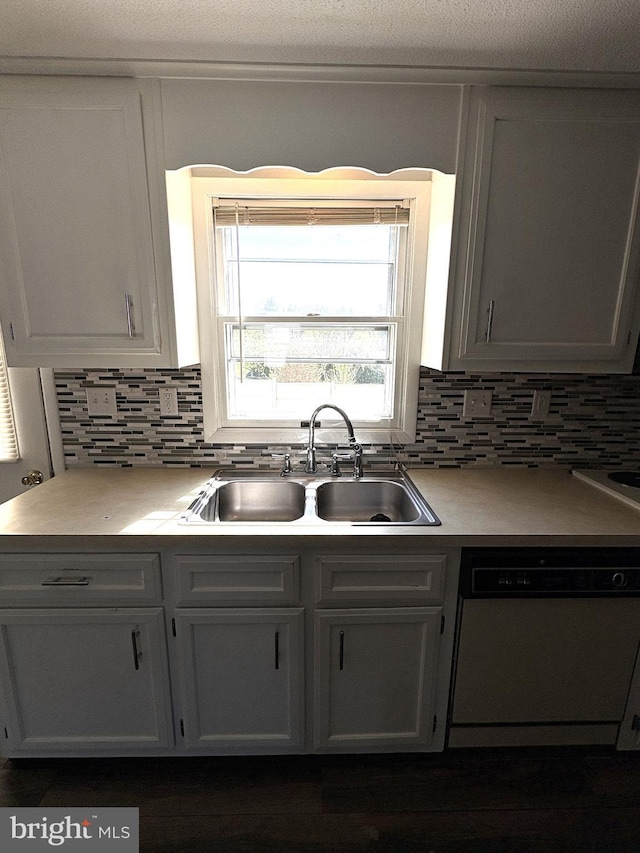 16 W Ninth St, Waynesboro, PA 17268 - kitchen featuring white dishwasher, a sink, decorative backsplash, and white cabinetry
