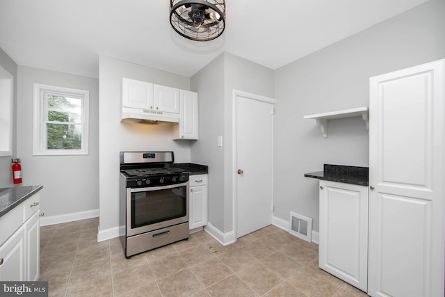 449 Audubon Ave, Audubon, NJ 08106 - kitchen with stainless steel gas stove, under cabinet range hood, white cabinets, baseboards, and dark stone countertops