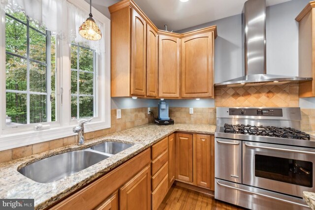 45 Saint Marys Ln, Stafford, VA 22556 - kitchen with range with two ovens, wall chimney exhaust hood, a sink, light stone counters, and decorative backsplash