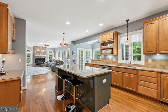 45 Saint Marys Ln, Stafford, VA 22556 - kitchen with a sink, a center island, light wood-style floors, decorative backsplash, and recessed lighting
