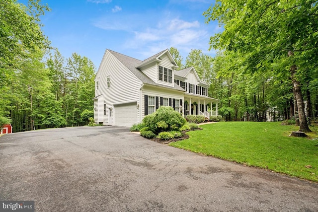 45 Saint Marys Ln, Stafford, VA 22556 - view of front of house featuring asphalt driveway, an attached garage, a front yard, and covered porch