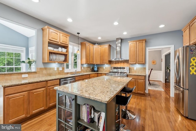45 Saint Marys Ln, Stafford, VA 22556 - kitchen featuring wall chimney exhaust hood, stainless steel appliances, open shelves, a breakfast bar area, and a kitchen island