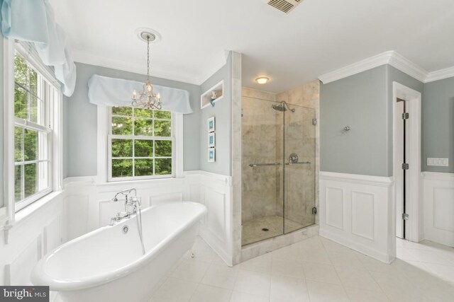 45 Saint Marys Ln, Stafford, VA 22556 - bathroom featuring wainscoting, a soaking tub, a stall shower, tile patterned floors, and a chandelier