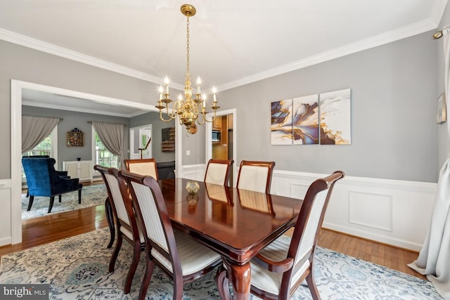 45 Saint Marys Ln, Stafford, VA 22556 - dining room with a chandelier, wood finished floors, ornamental molding, a wainscoted wall, and a decorative wall