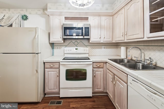 38 Western Winds Cir Unit 38, Baltimore, MD 21244 - kitchen with white appliances, a sink, tile countertops, tasteful backsplash, and dark wood-style floors
