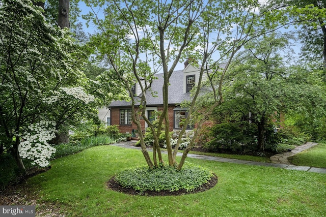 5408 Wehawken Rd, Bethesda, MD 20816 - view of front of home featuring brick siding, a front yard, a chimney, and roof with shingles