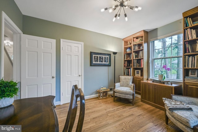 5408 Wehawken Rd, Bethesda, MD 20816 - sitting room with a chandelier, wood finished floors, and baseboards