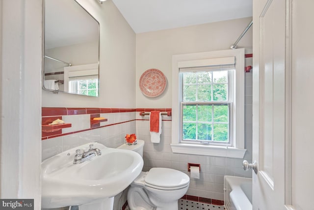 5408 Wehawken Rd, Bethesda, MD 20816 - full bathroom featuring tile walls, toilet, a sink, wainscoting, and tile patterned floors