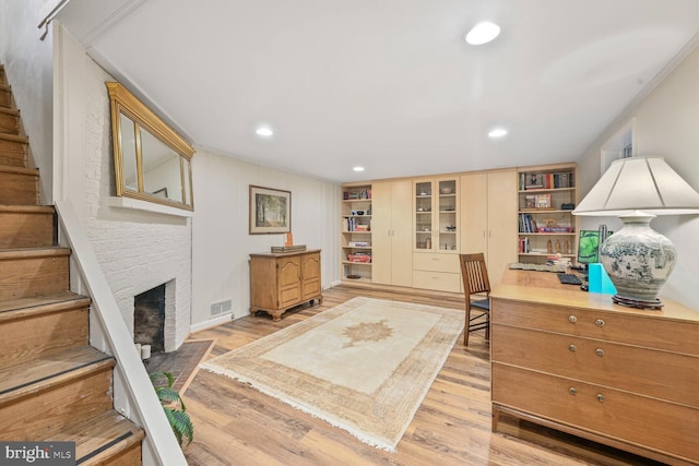 5408 Wehawken Rd, Bethesda, MD 20816 - office with light wood finished floors, a brick fireplace, recessed lighting, and built in shelves