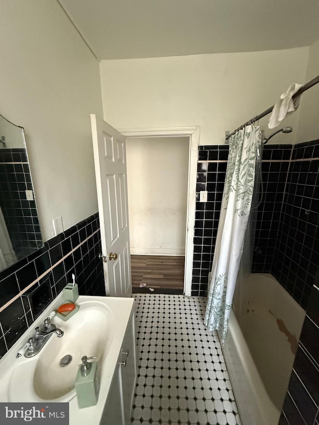1512 Lindley Ave, Philadelphia, PA 19141 - full bath featuring tile walls, vanity, shower / tub combo, wainscoting, and tile patterned flooring