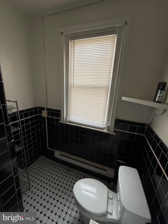 1512 Lindley Ave, Philadelphia, PA 19141 - bathroom featuring tile walls, toilet, a baseboard radiator, and a wainscoted wall