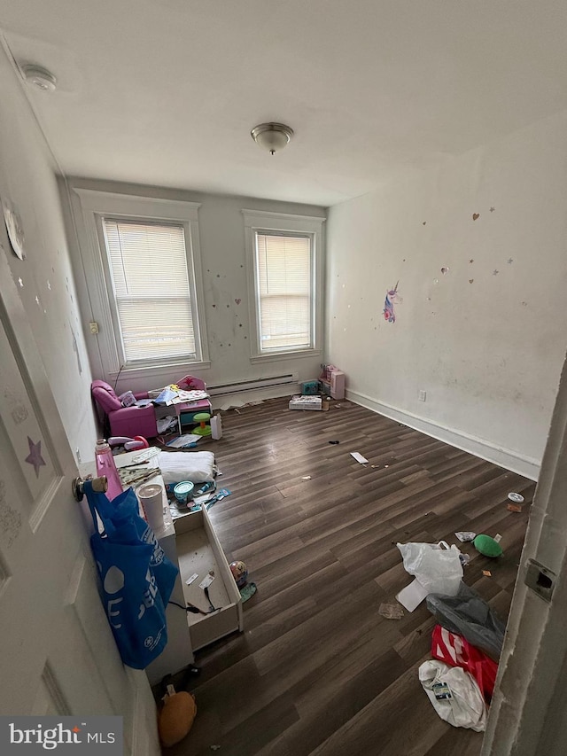1512 Lindley Ave, Philadelphia, PA 19141 - empty room featuring wood finished floors, a baseboard heating unit, and a smoke detector