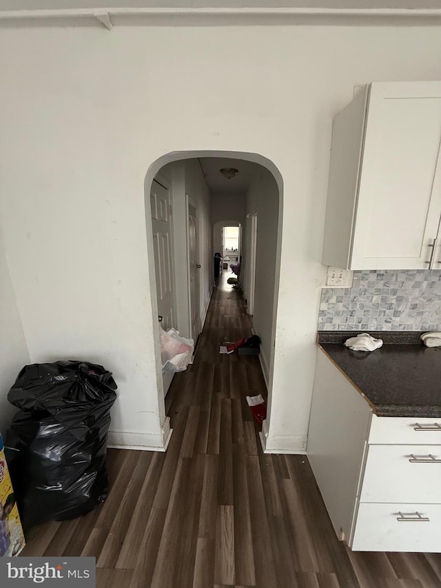 1512 Lindley Ave, Philadelphia, PA 19141 - hallway featuring dark wood finished floors, baseboards, and arched walkways