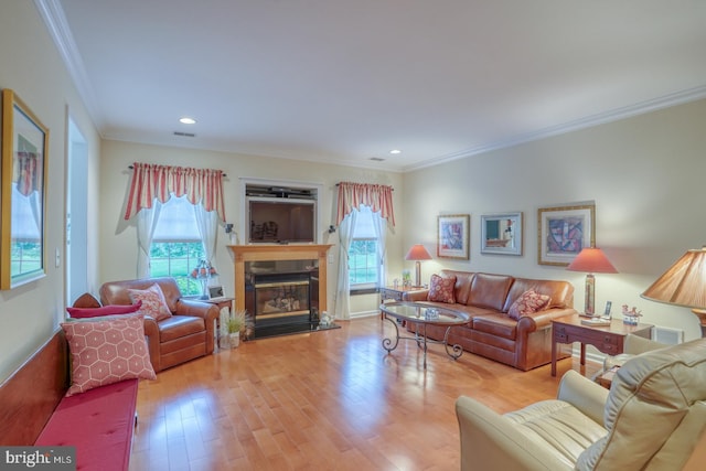 73 Springmill Dr, Middletown, DE 19709 - living area with wood finished floors, crown molding, a glass covered fireplace, and recessed lighting