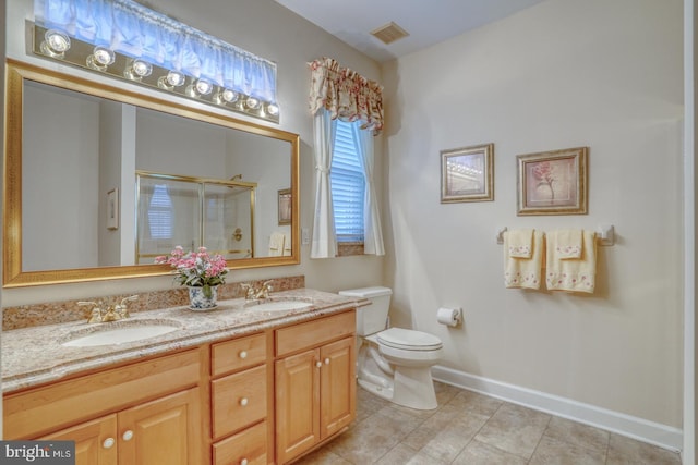 73 Springmill Dr, Middletown, DE 19709 - bathroom featuring double vanity, a shower stall, tile patterned floors, toilet, and baseboards
