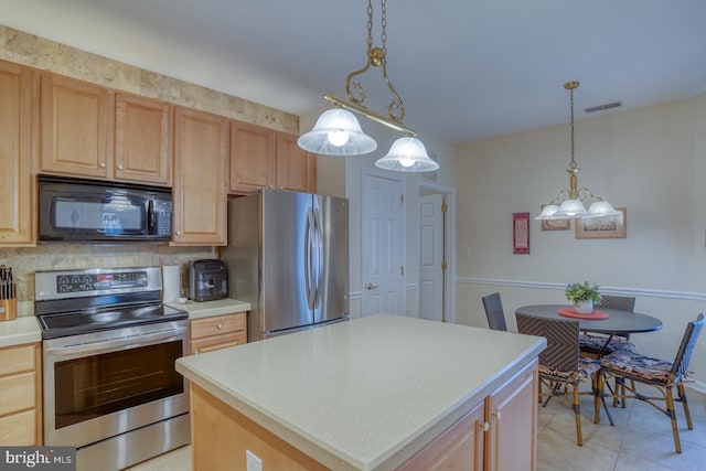 73 Springmill Dr, Middletown, DE 19709 - kitchen featuring appliances with stainless steel finishes, backsplash, light countertops, a chandelier, and a center island