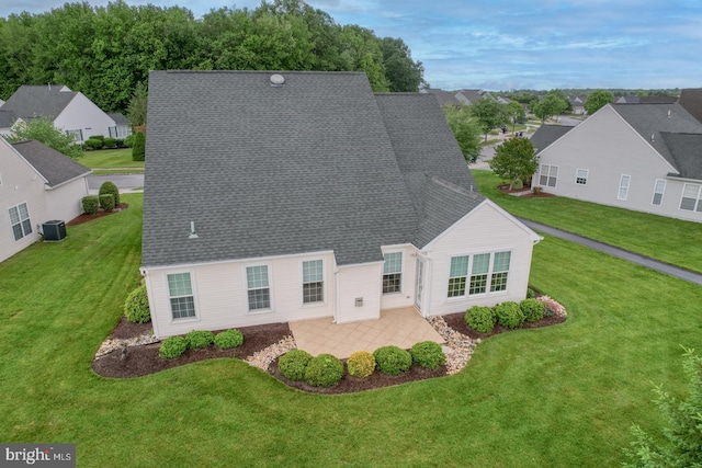 73 Springmill Dr, Middletown, DE 19709 - view of front of home featuring a front lawn, a patio area, a residential view, central air condition unit, and a shingled roof