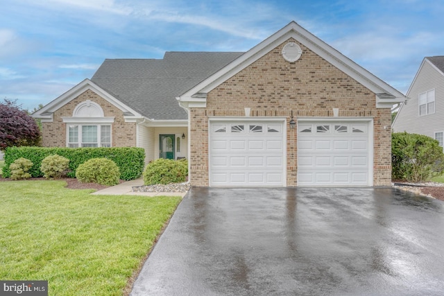73 Springmill Dr, Middletown, DE 19709 - ranch-style home featuring brick siding, asphalt driveway, an attached garage, a front lawn, and a shingled roof