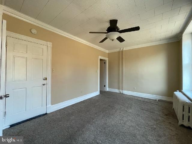 102 N 11th St, Reading, PA 19601 - unfurnished bedroom with carpet, radiator heating unit, ornamental molding, baseboards, and ceiling fan