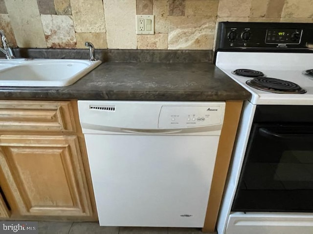 102 N 11th St, Reading, PA 19601 - kitchen view of range with electric cooktop, white dishwasher, a sink, and dark countertops