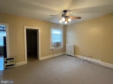 102 N 11th St, Reading, PA 19601 - unfurnished bedroom with radiator, cooling unit, baseboards, carpet, and ceiling fan