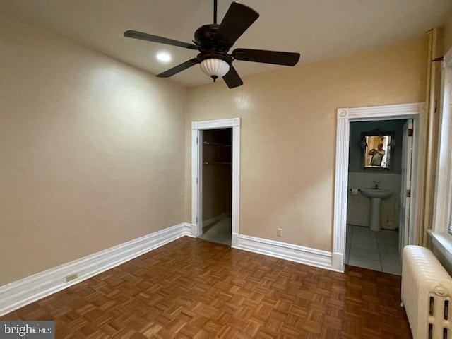 102 N 11th St, Reading, PA 19601 - unfurnished bedroom with radiator, baseboards, a sink, a spacious closet, and a closet