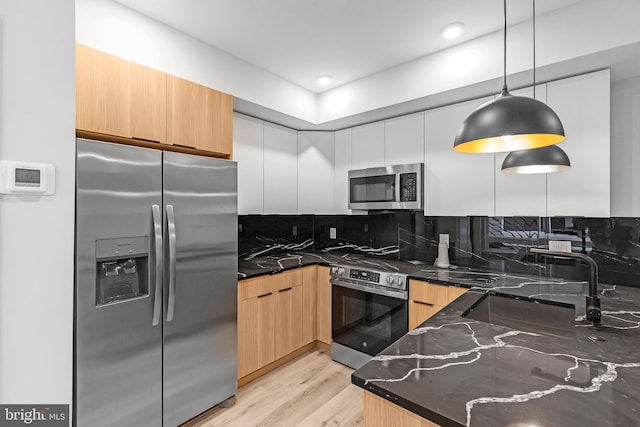 2937 Page St, Philadelphia, PA 19121 - kitchen featuring stainless steel appliances, modern cabinets, dark stone counters, tasteful backsplash, and a sink