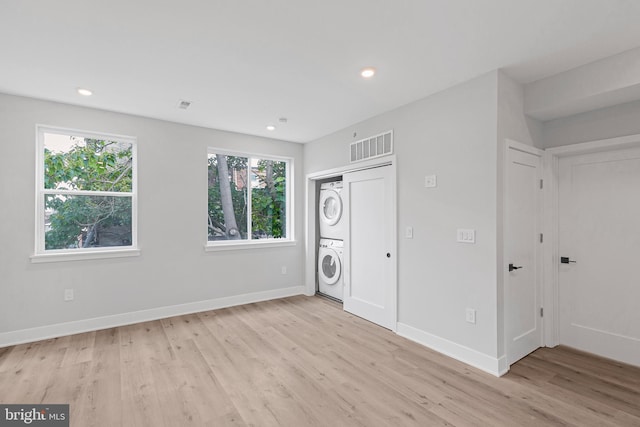 2937 Page St, Philadelphia, PA 19121 - unfurnished bedroom featuring stacked washer / dryer, light wood finished floors, baseboards, and recessed lighting