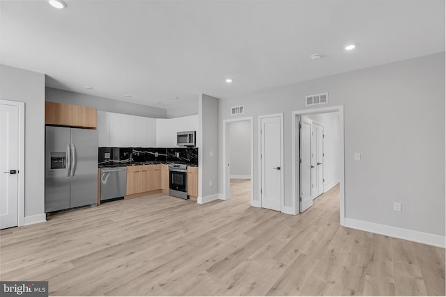 2937 Page St, Philadelphia, PA 19121 - kitchen featuring stainless steel appliances, tasteful backsplash, light wood finished floors, baseboards, and dark countertops