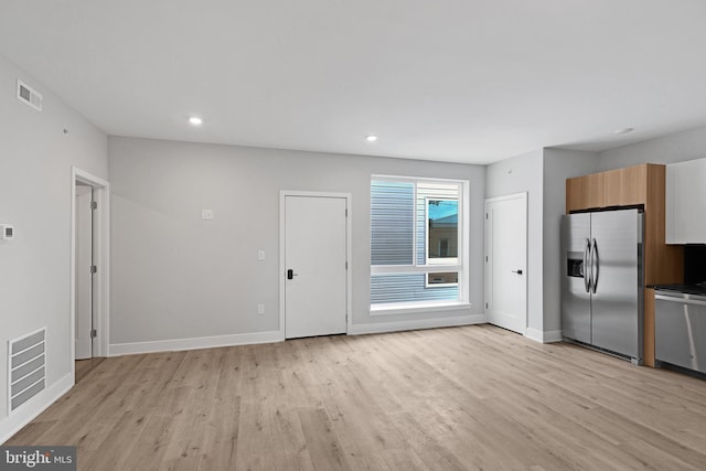 2937 Page St, Philadelphia, PA 19121 - unfurnished living room with light wood-type flooring, baseboards, and recessed lighting