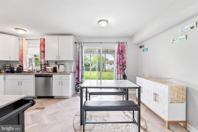 35 Mullshire Ln, Willingboro, NJ 08046 - kitchen with stainless steel dishwasher, white cabinets, decorative backsplash, light stone countertops, and a sink