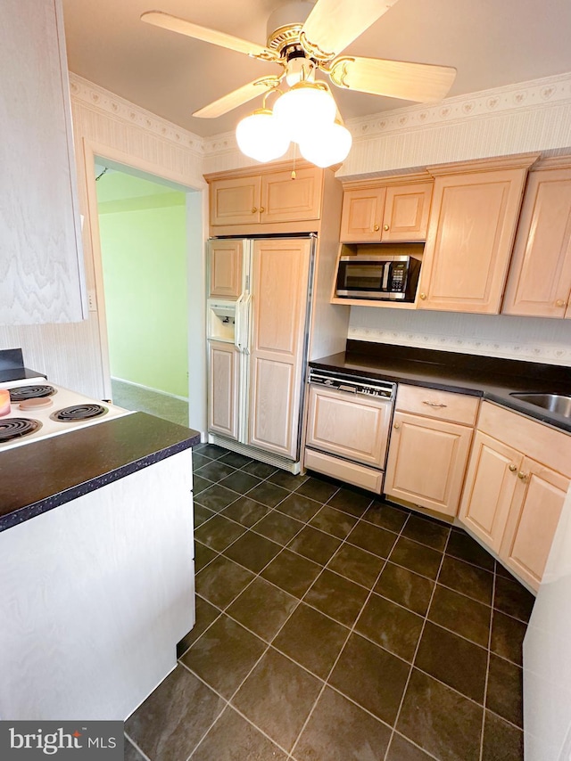 737 Hardwick Pl, York, PA 17404 - kitchen with paneled appliances, light brown cabinetry, dark countertops, ceiling fan, and dark tile patterned flooring