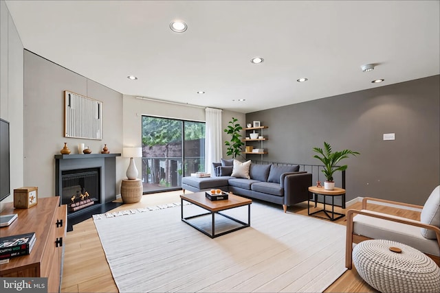 2213 Race St Unit 202, Philadelphia, PA 19103 - living area featuring recessed lighting, light wood finished floors, and a fireplace with flush hearth