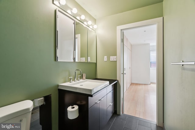 2213 Race St Unit 202, Philadelphia, PA 19103 - half bathroom with toilet, vanity, and tile patterned floors