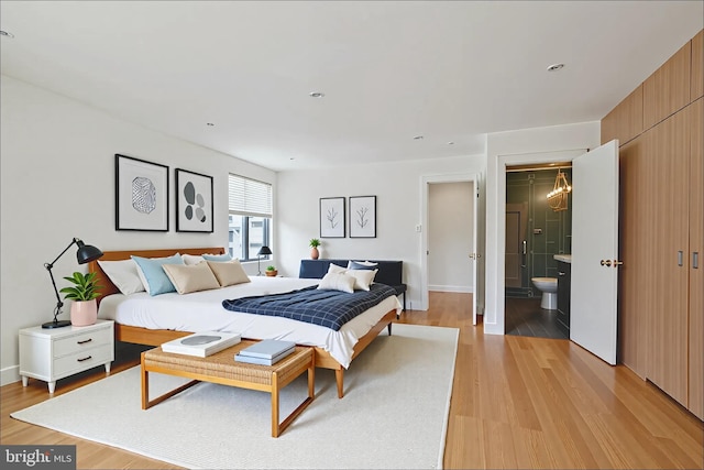 2213 Race St Unit 202, Philadelphia, PA 19103 - bedroom with light wood-style floors, connected bathroom, and baseboards