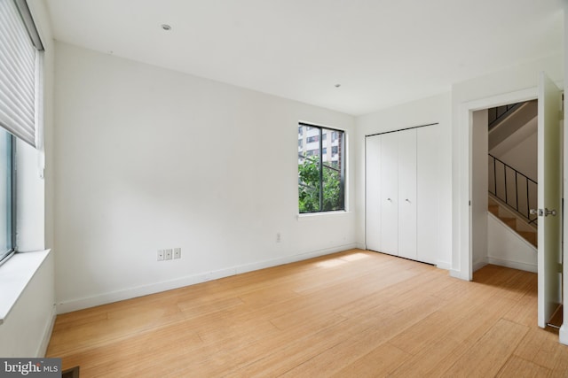 2213 Race St Unit 202, Philadelphia, PA 19103 - unfurnished bedroom featuring wood finished floors, baseboards, and a closet