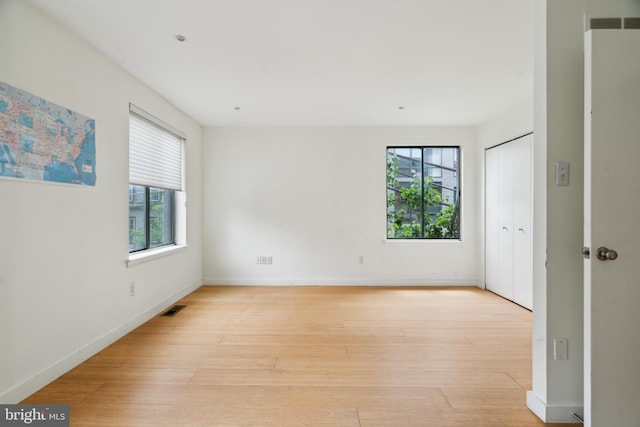 2213 Race St Unit 202, Philadelphia, PA 19103 - spare room featuring healthy amount of natural light, light wood-style flooring, and baseboards