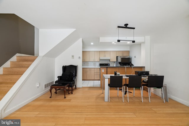 2213 Race St Unit 202, Philadelphia, PA 19103 - kitchen with backsplash, light wood-style floors, light brown cabinetry, baseboards, and an office area