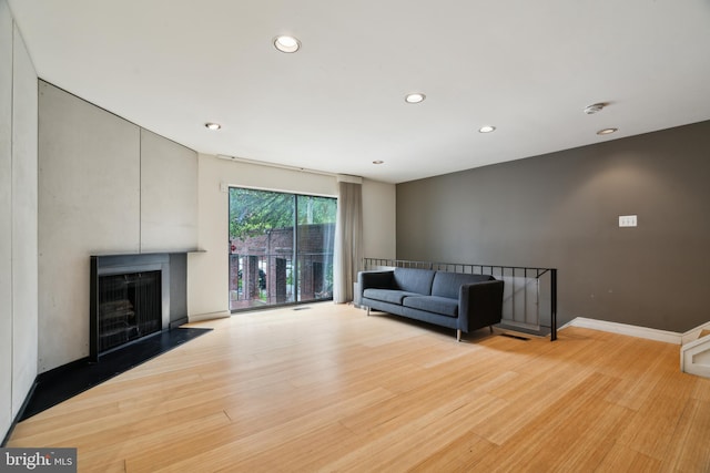 2213 Race St Unit 202, Philadelphia, PA 19103 - unfurnished living room featuring recessed lighting, light wood-style floors, a fireplace, and baseboards