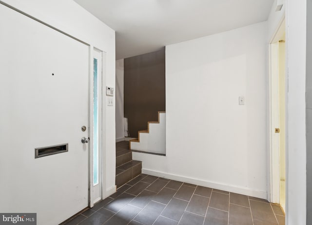 2213 Race St Unit 202, Philadelphia, PA 19103 - foyer with dark tile patterned flooring, stairs, and baseboards