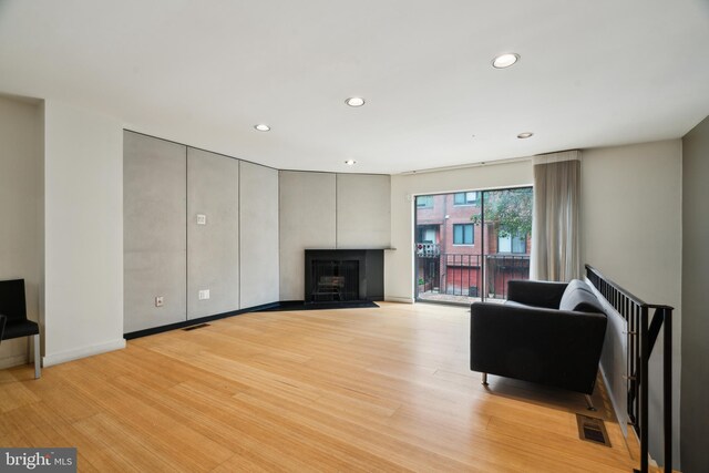 2213 Race St Unit 202, Philadelphia, PA 19103 - living area with recessed lighting, a fireplace, light wood-style flooring, and baseboards