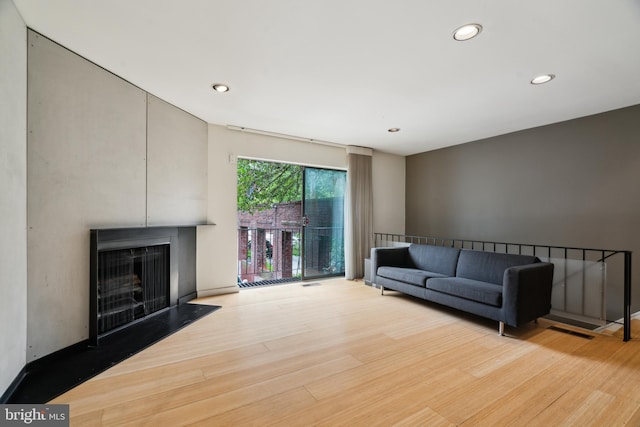 2213 Race St Unit 202, Philadelphia, PA 19103 - living room with wood finished floors, a fireplace, and recessed lighting