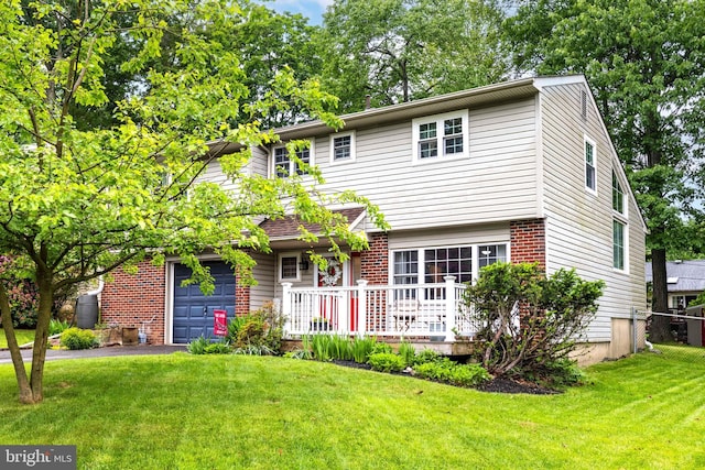 167 Windmill Rd, Willow Grove, PA 19090 - view of front of home with a front lawn, asphalt driveway, an attached garage, and brick siding