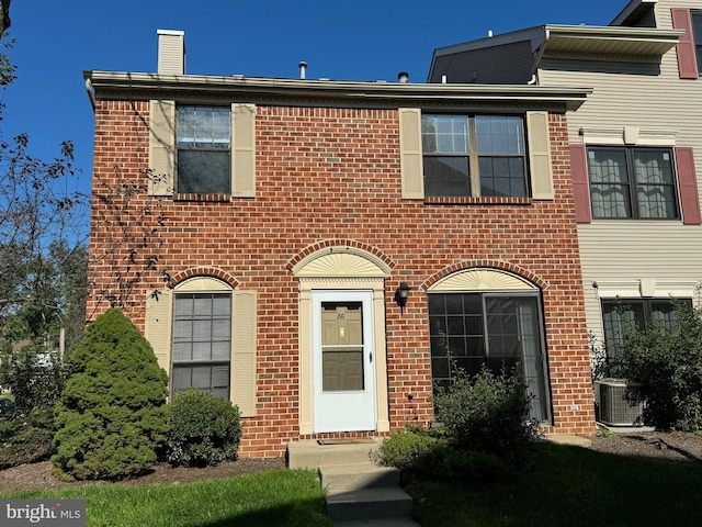 86 Oneill Ct, Trenton, NJ 08648 - view of front facade with brick siding, cooling unit, and a chimney