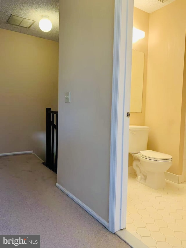 86 Oneill Ct, Trenton, NJ 08648 - hallway featuring an upstairs landing, baseboards, carpet floors, a textured ceiling, and tile patterned flooring
