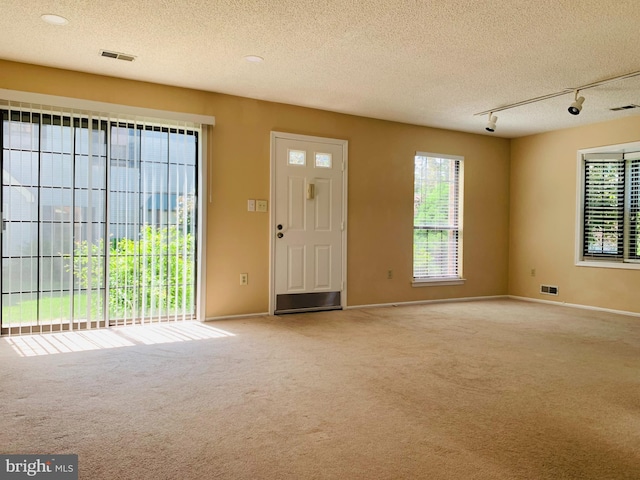 86 Oneill Ct, Trenton, NJ 08648 - foyer entrance featuring carpet floors, track lighting, healthy amount of natural light, and a textured ceiling