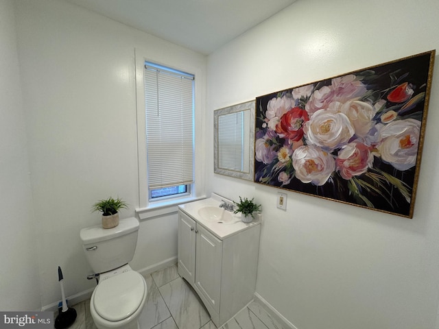 2411 N W St, Wilmington, DE 19802 - half bathroom with baseboards, vanity, marble look tiles, and toilet
