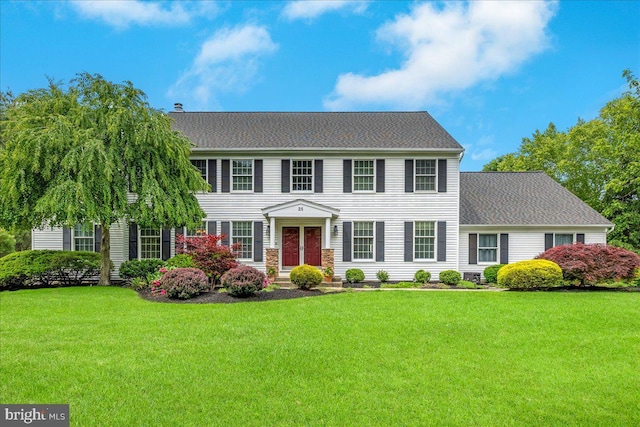 25 Ginnie Ln, West Windsor, NJ 08550 - colonial-style house with a front lawn and roof with shingles