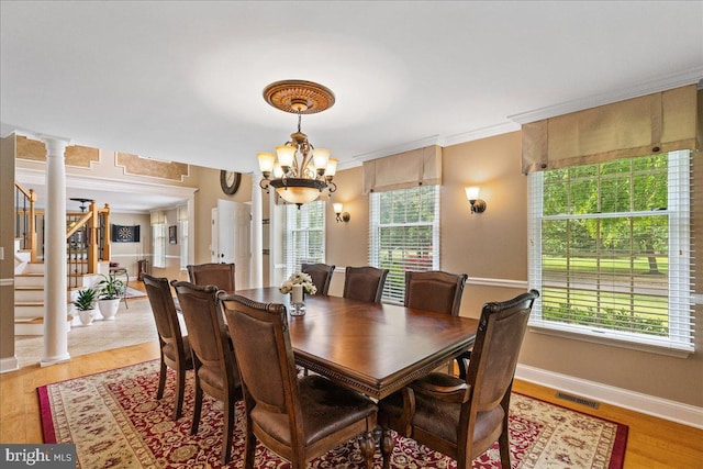 25 Ginnie Ln, West Windsor, NJ 08550 - dining area with a chandelier, stairway, baseboards, light wood-style floors, and crown molding