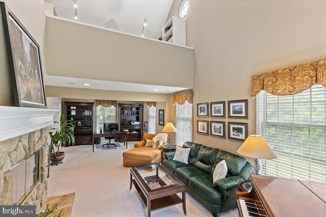 25 Ginnie Ln, West Windsor, NJ 08550 - carpeted living area with a fireplace and a towering ceiling